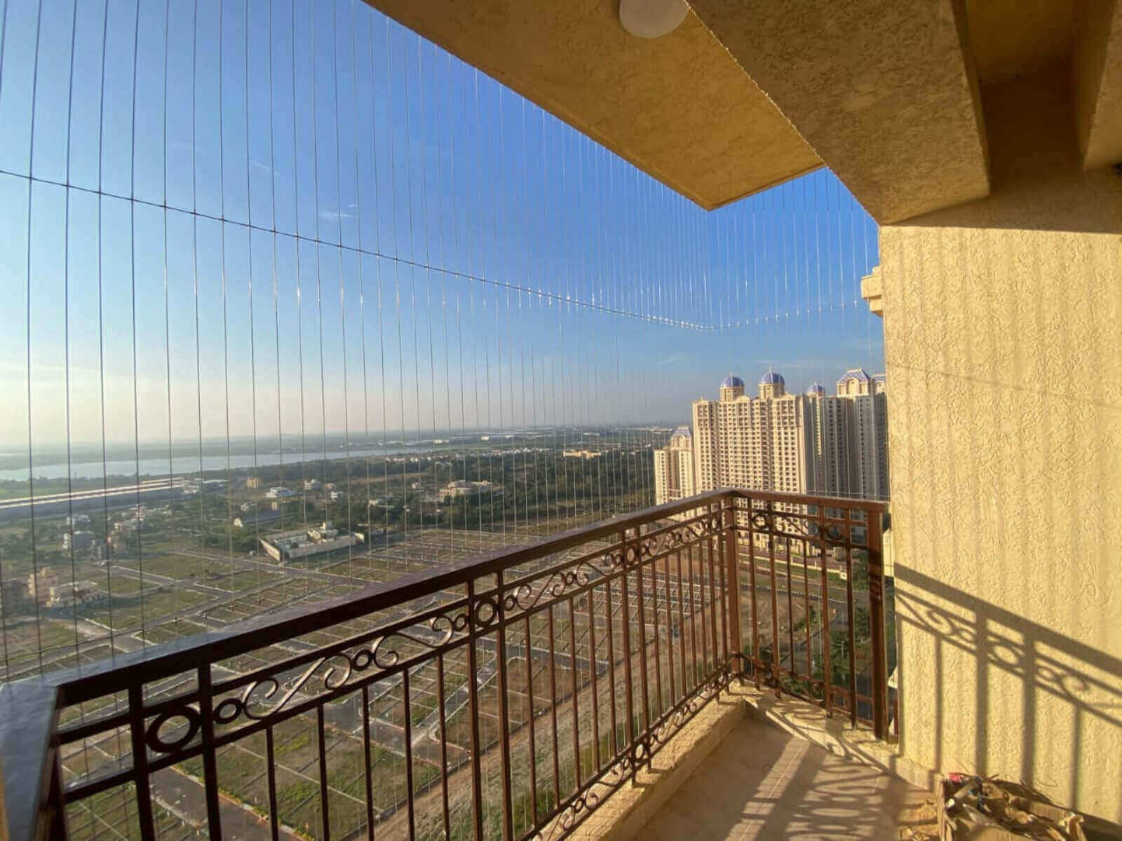 Invisible grill with thin stainless cables on a balcony